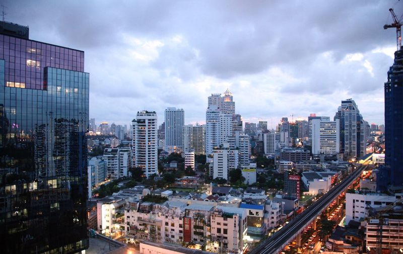 High angle view of illuminated buildings against sky in city. bangkok, thailand