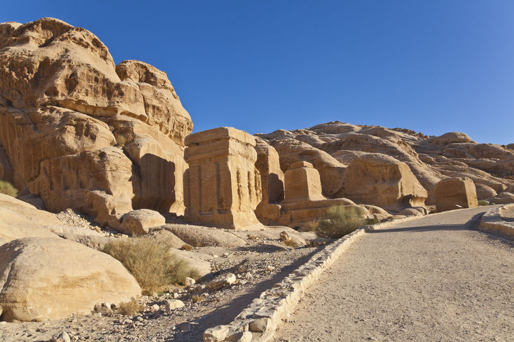 Scenic view of monuments against blue sky