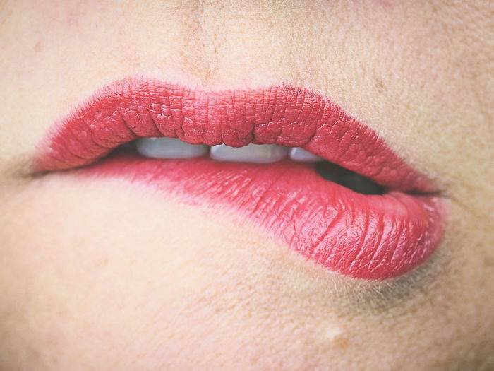 Close-up of woman biting lips