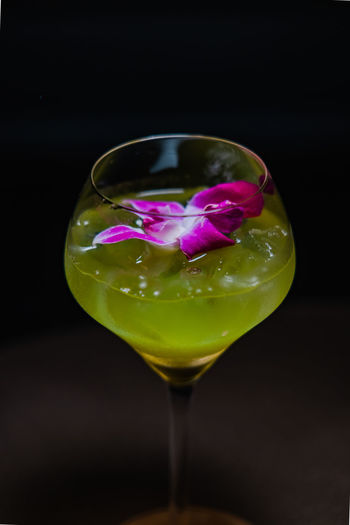 Close-up of drink on glass against black background