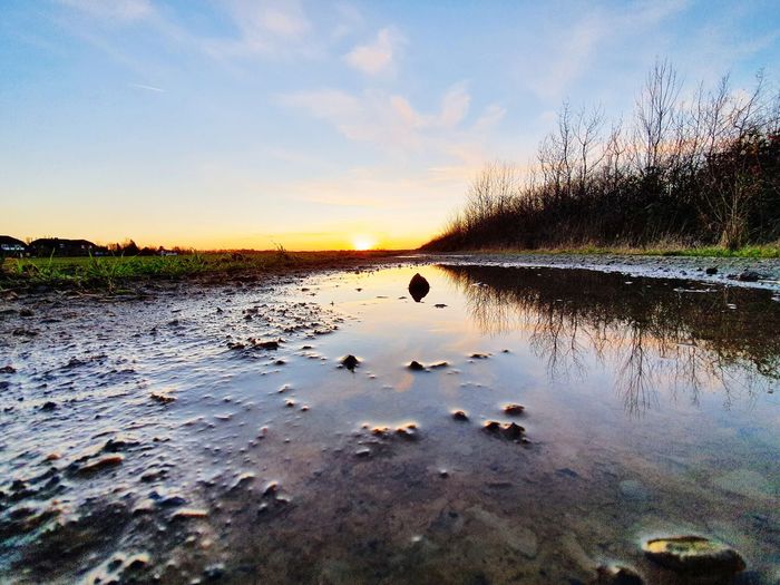 Scenic view of lake against sky during sunset