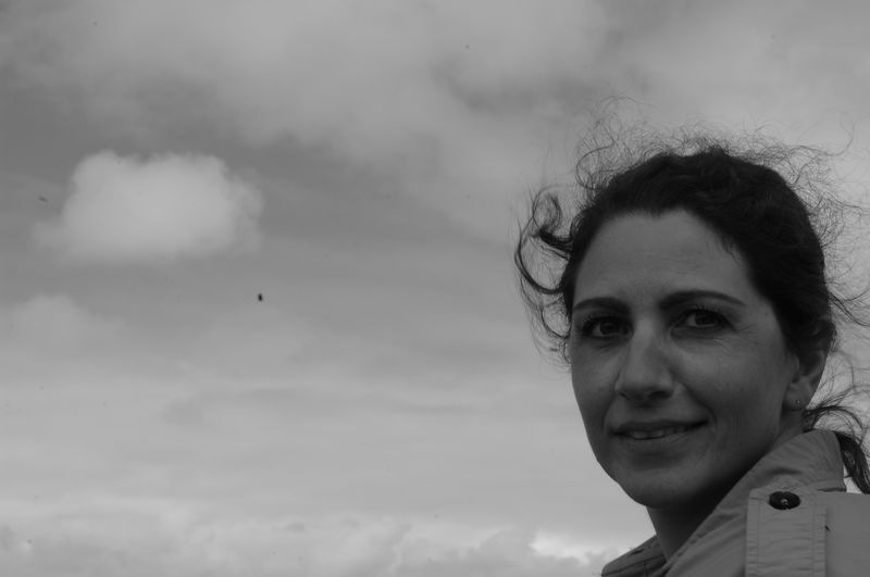 Portrait of smiling woman against sky