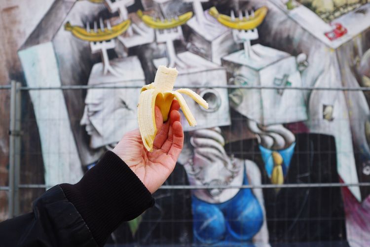 Cropped hand holding banana