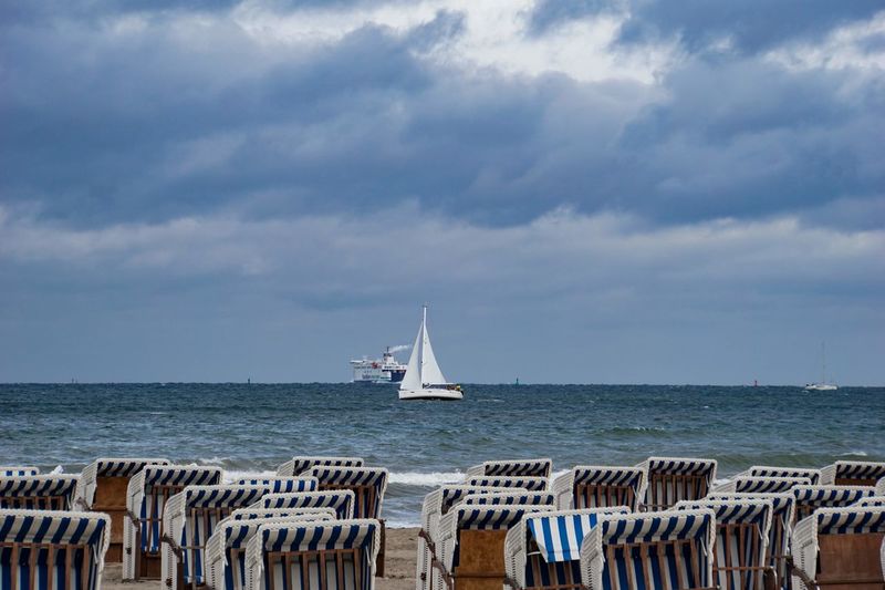 Sailboat sailing on sea against sky