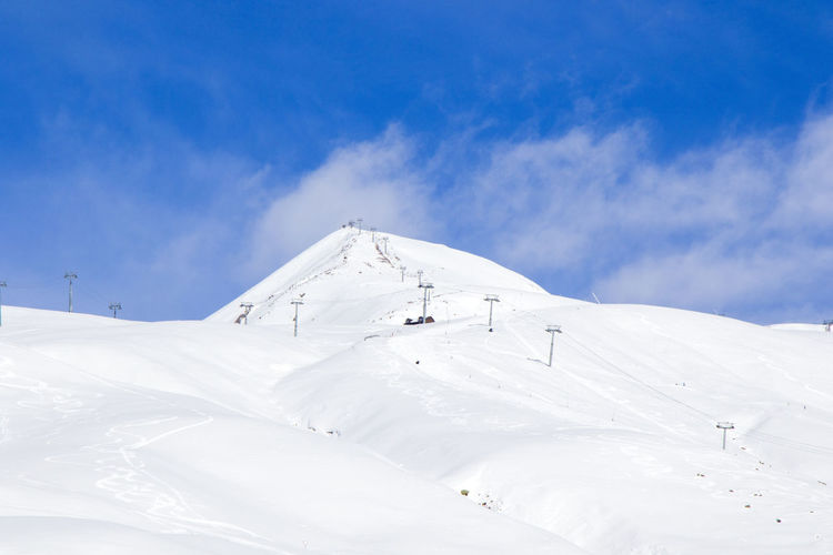 Georgian ski resort in gudauri. snowy mountains, daytime and sunlight.