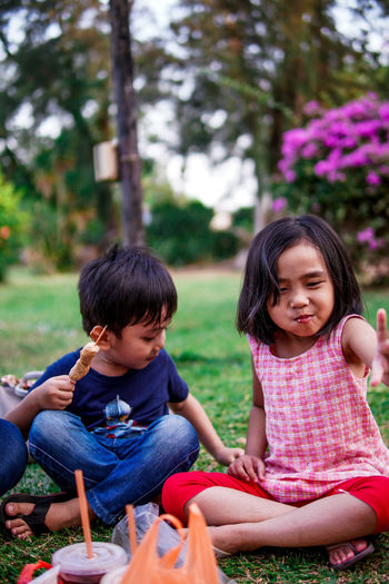 Boy and girl sitting outdoor
