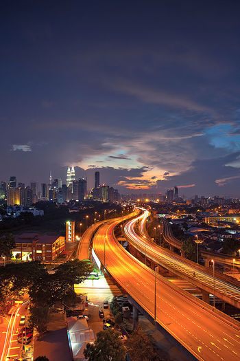 High angle view of illuminated cityscape at dusk
