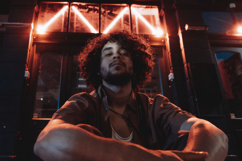 Man looking at camera and neon lights