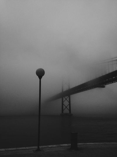April 25th bridge on tagus river during foggy weather