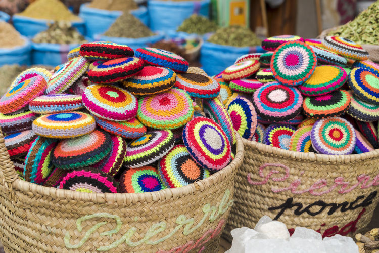 Close-up of multi colored wicker basket for sale in market