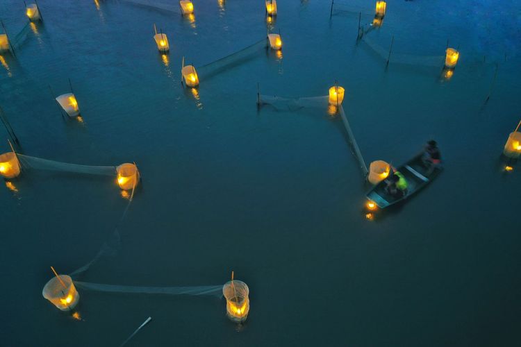 High angle view of illuminated floating on sea