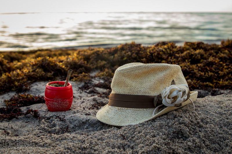 Hat and mate on sand in the beach