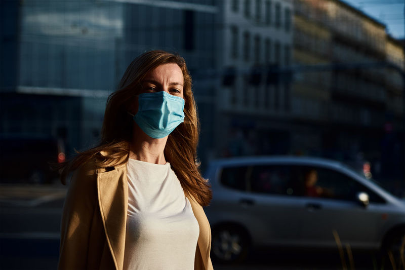 Woman in protective mask at city street