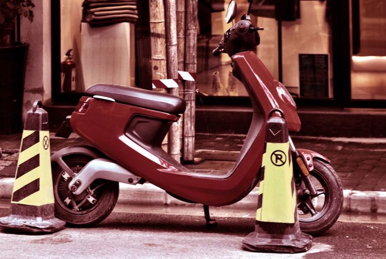 Side view of scooter parked on street