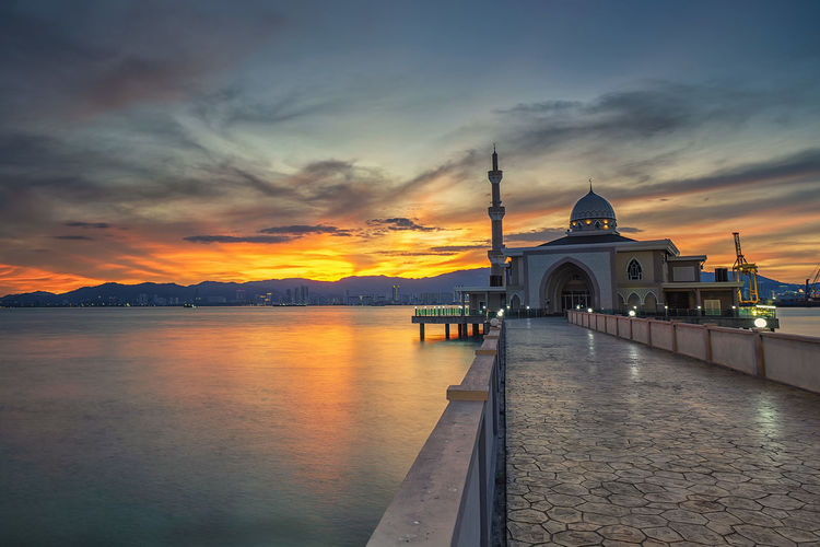 View of penang port floating mosque against sky during sunset