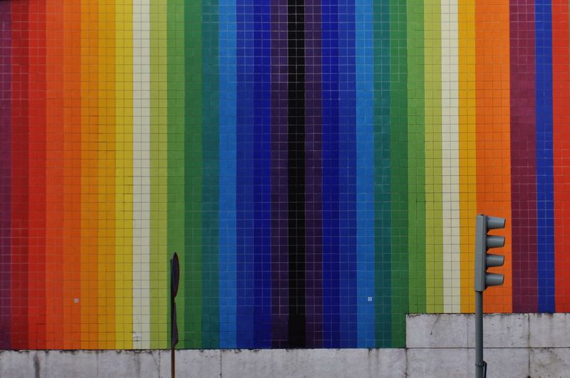 Road signal against colorful wall