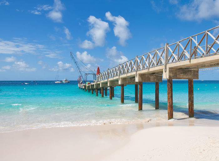 View of bridge over sea against cloudy sky