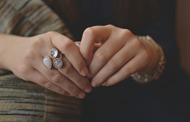 Midsection of woman hands wearing ring