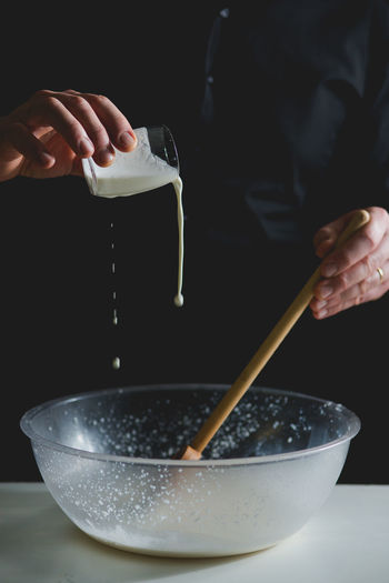 Close-up of chef's hands mixing ingredients