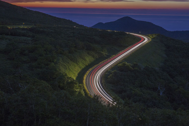 High angle view of mountain road against sky at sunset