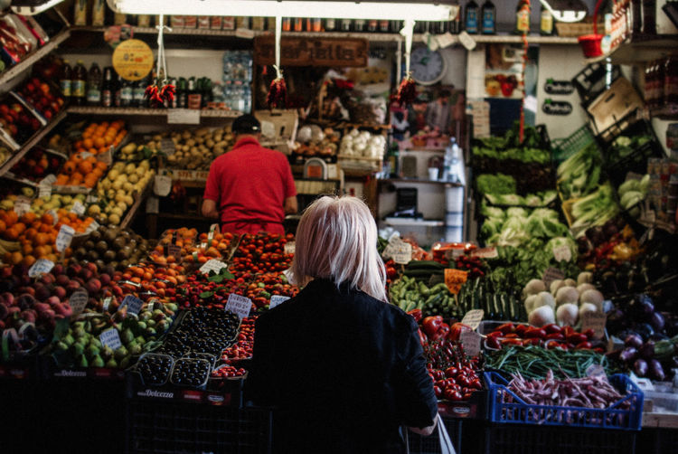 Rear view of woman at market stall
