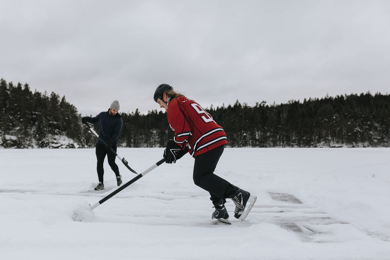 Men ice-skating on frozen lake