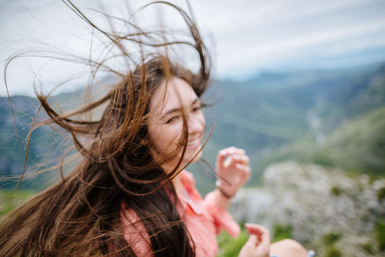 Close-up of young woman in wind