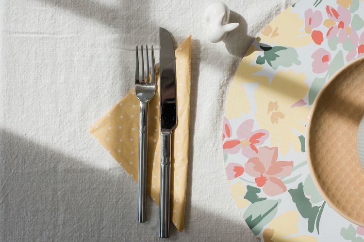 Cutlery and napkin on a decorated dinner table in summer and spring