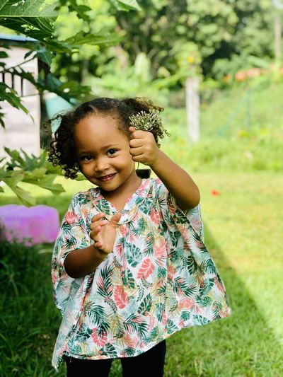 Mixed beautiful little girl holding flowers 