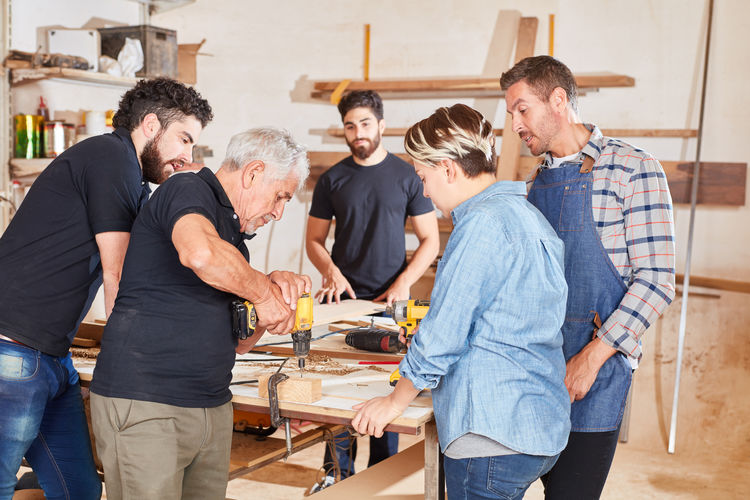 People working on table in workshop