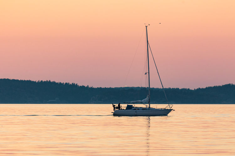 Sailboat on calm waters at sunset