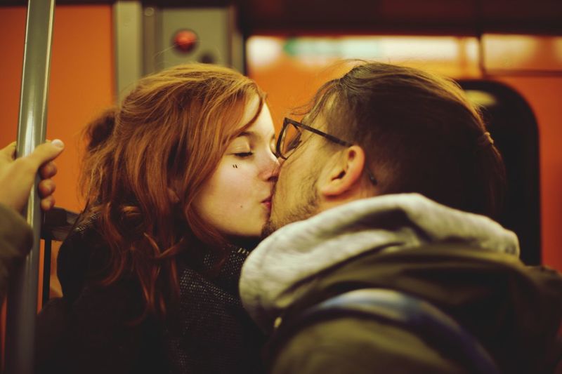 Young couple kissing in train