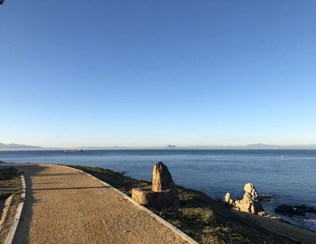 Scenic view of sea against clear blue sky