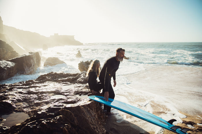 Couple with surfboard at beach