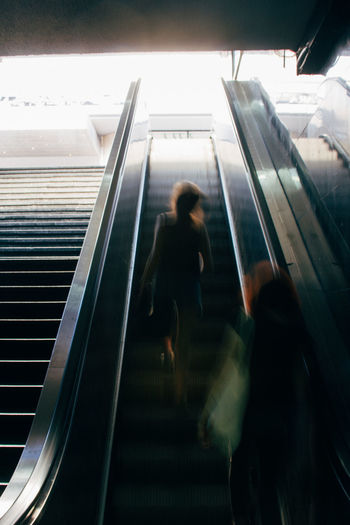 Blurred motion of people on escalator