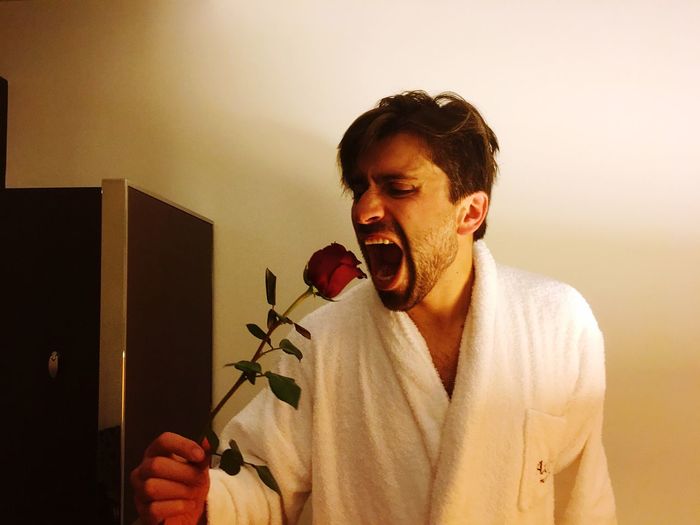 Close-up of man holding rose