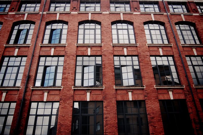 Full frame shot of building with reflection on window glass