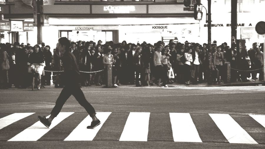 People crossing street in city