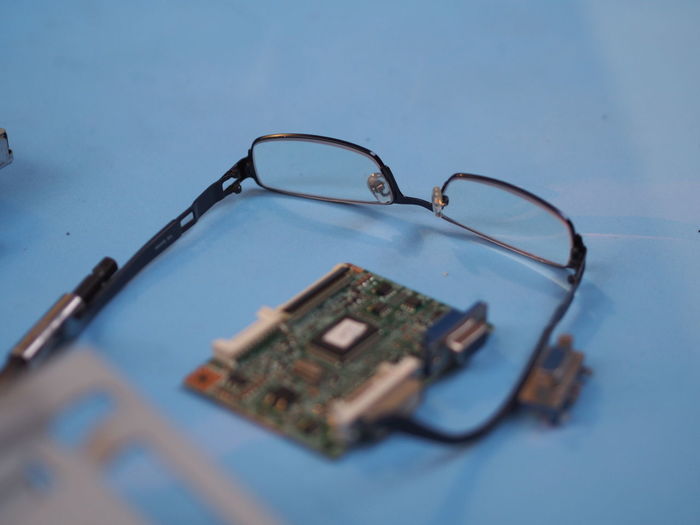 High angle view of eyeglasses and motherboard on table