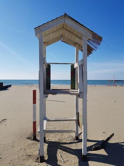 Built structure on beach against sky