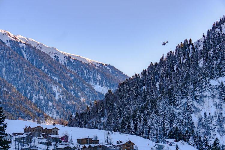 Panoramic view of snowcapped mountains against clear sky