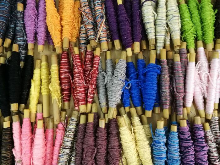 Full frame shot of colorful thread spools for sale in market