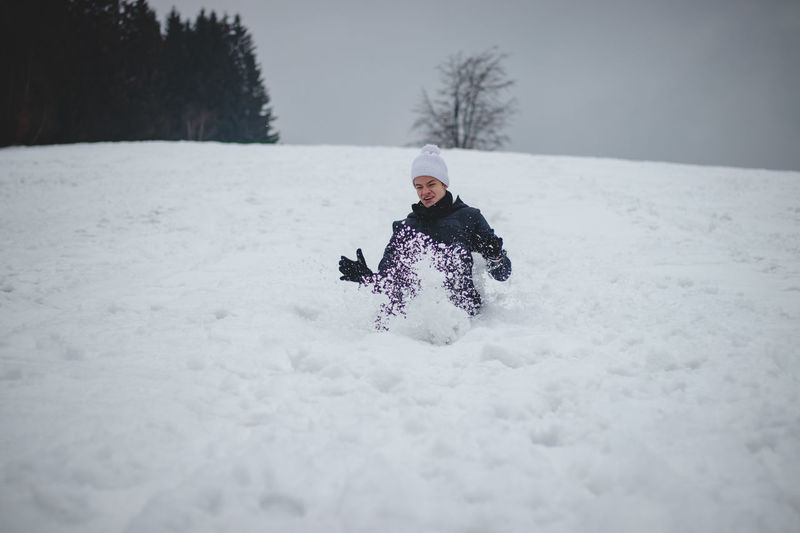 Man on snow covered land