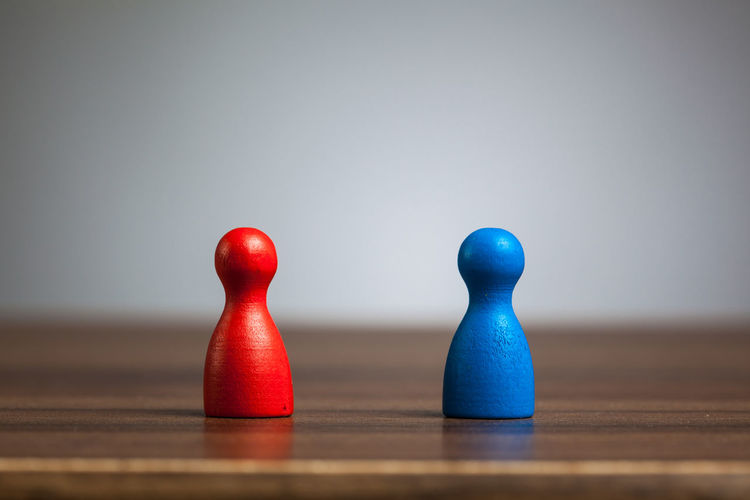 Close-up of blue balls on table against white background