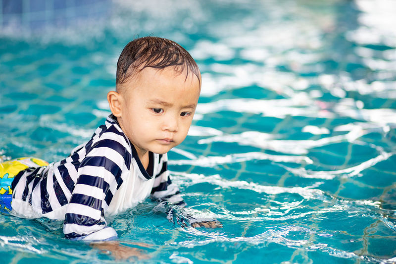 Cute boy swimming in pool