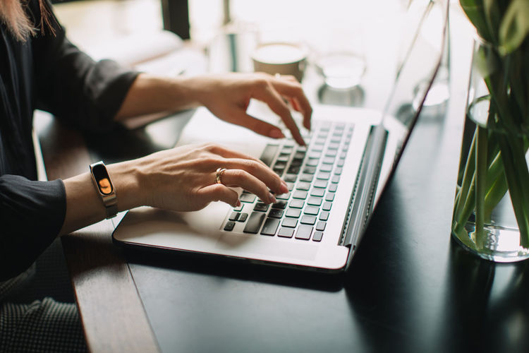 Adult Communication Computer Connection Finger Hand Human Body Part Human Hand Indoors Keyboard Laptop One Person Real People Selective Focus Surfing The Net Table Technology Typing Using Laptop Wireless Technology Women Working