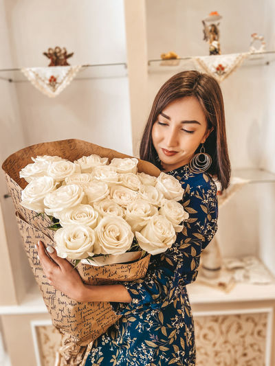 Close-up of woman holding rose bouquet