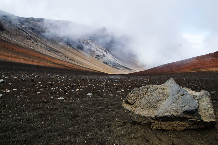 Smoke emitting from volcanic mountain against sky