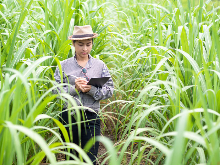 Man looking at camera while standing in field