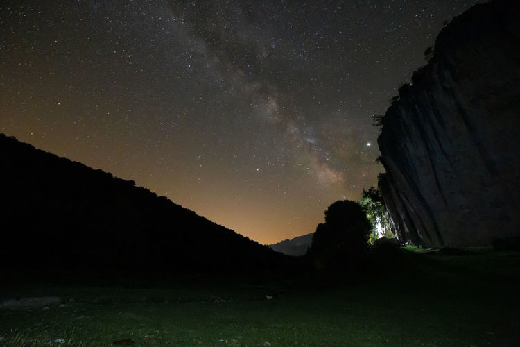 Low angle view of rock formation against sky at night